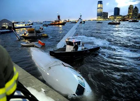 A US Airways plane rests against a retaining wall after the pilot ditched the disabled jetliner into the frigid Hudson River in New York Thursday, Jan. 15, 2009. A collision with a flock of birds apparently knocked out both engines, but rescuers pulled all 155 people on board into boats as the plane sank. (AP Photo/Louis Lanzano)