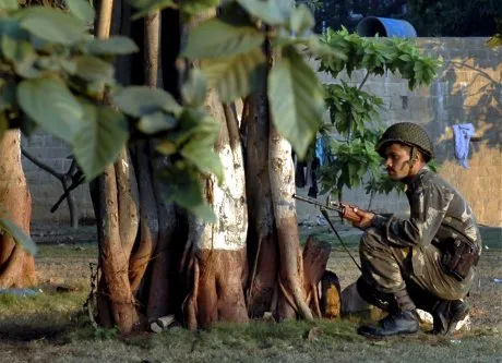 An Indian Army soldier takes position outside the Taj Mahal hotel in Mumbai, India, Thursday, Nov. 27, 2008. Teams of gunmen stormed luxury hotels, a popular restaurant, a crowded train station and a Jewish group's headquarters, killing people, and holding Westerners hostage in coordinated attacks on the nation's commercial center that were blamed on Muslim militants. (AP Photo)